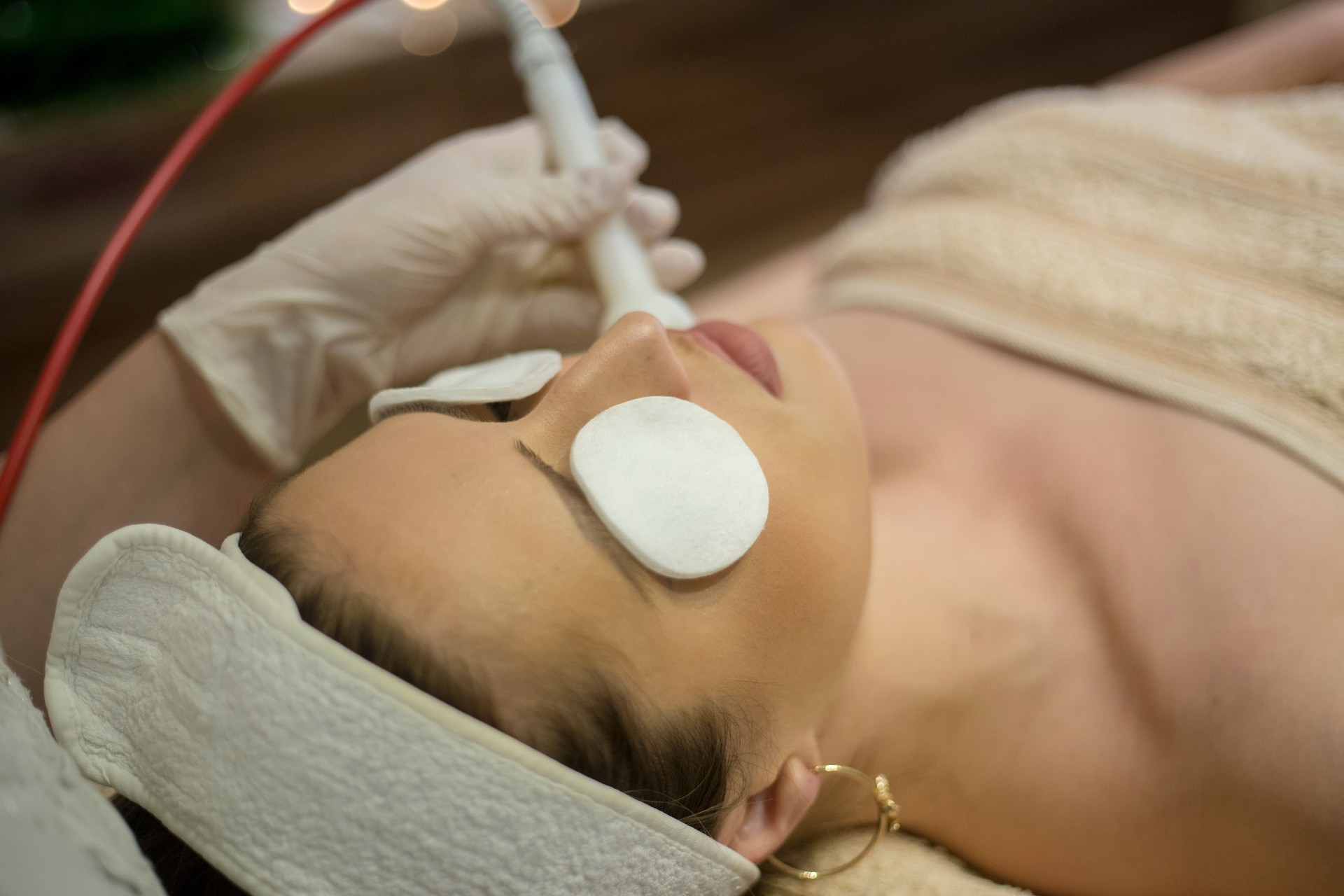 Woman at the spa getting a rejuvenation treatment on her face